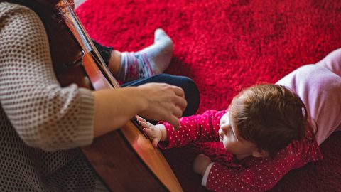 Illustrative photo: toddler, guitar, mother